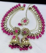 Boysenberry ruby earrings with beautiful tika made of kundan beads and the material is alloy