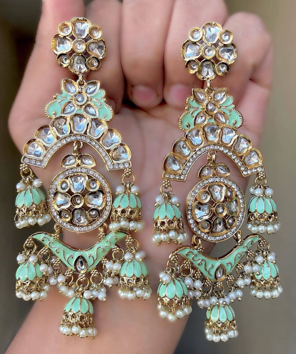 Gossip Green Mehendi Polish Pachi Kundan Long Earrings having base metal alloy and gold plated with artificial Kundan stones and pearls, adjustable and made in India. which is held in hands and presented