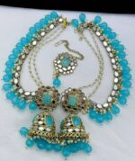 Lotion blue pearls mirror earrings with beautiful tika made of kundan beads and the material is alloy