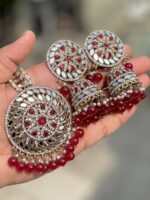 Mirror Jhumka with artificial maroon pearls and beautiful tikka which is made of gold-plated alloy and is projected on the palm