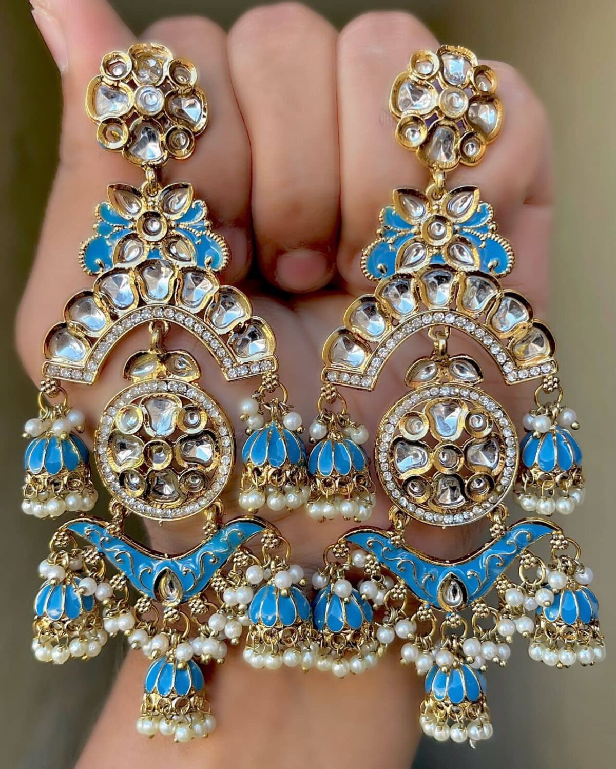 cyan blue Mehendi Polish Pachi Kundan Long Earrings having base metal alloy and gold plated with artificial Kundan stones and pearls, adjustable and made in India. which is held in hands and presented