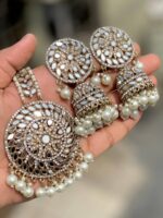 Mirror Jhumka with artificial White pearls and beautiful tikka which is made of gold-plated alloy and is projected on the palm