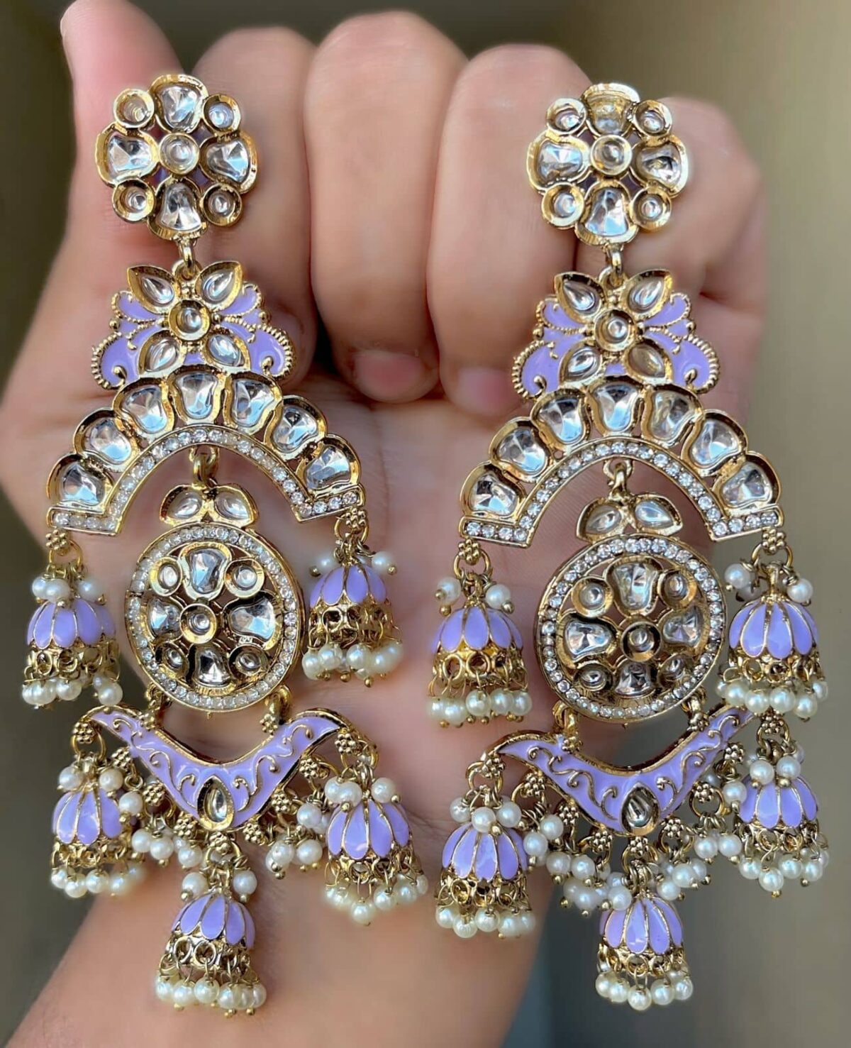 wild blue yonder Mehendi Polish Pachi Kundan Long Earrings having base metal alloy and gold plated with artificial Kundan stones and pearls, adjustable and made in India. which is held in hands and presented